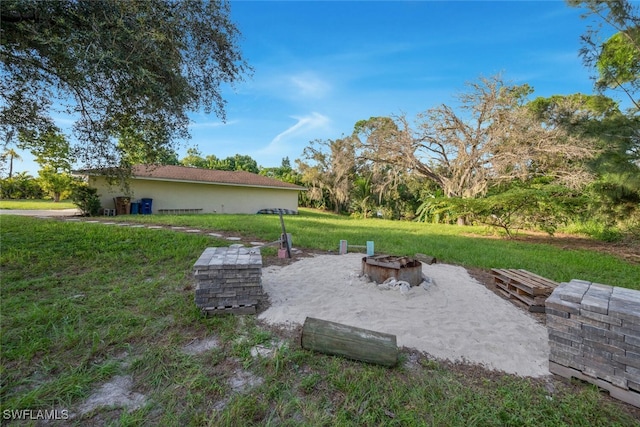 view of yard with an outdoor fire pit