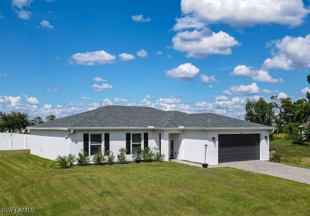 view of front of property featuring a garage and a front yard