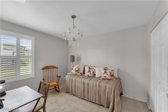 bedroom with an inviting chandelier, a closet, and light tile patterned floors