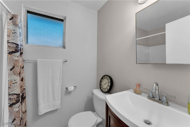 bathroom with vanity, toilet, and a shower with curtain