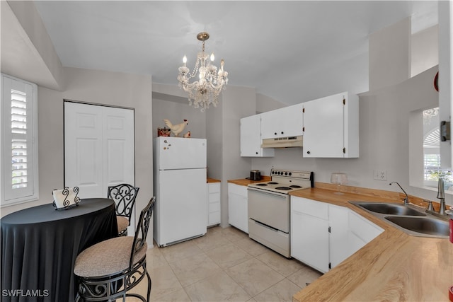 kitchen with white cabinets, pendant lighting, sink, white appliances, and a chandelier