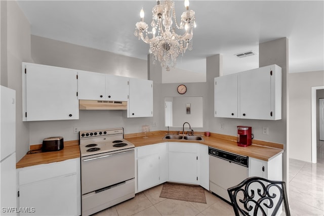 kitchen with sink, a notable chandelier, white cabinets, hanging light fixtures, and white appliances