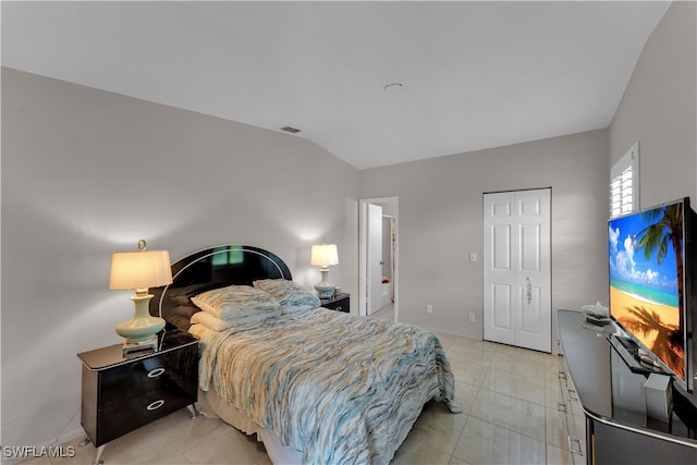 bedroom with lofted ceiling and a closet