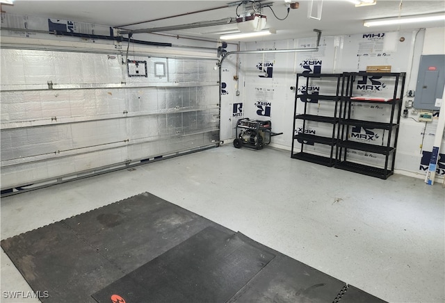 garage with a garage door opener and electric panel