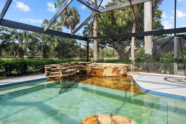 view of pool with a patio and a lanai