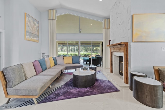 living room with vaulted ceiling and a large fireplace