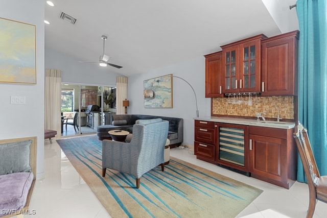 living room with wine cooler, wet bar, light tile patterned floors, lofted ceiling, and ceiling fan