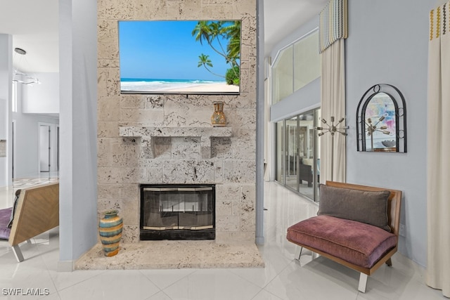 living room with tile patterned flooring and a tile fireplace