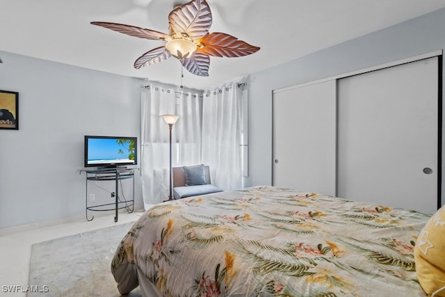 bedroom with ceiling fan and a closet