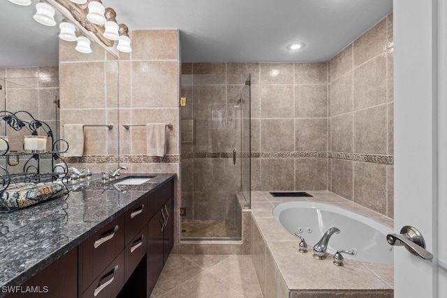 bathroom featuring tile walls, vanity, and separate shower and tub