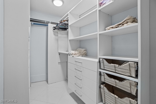 spacious closet featuring light tile patterned floors