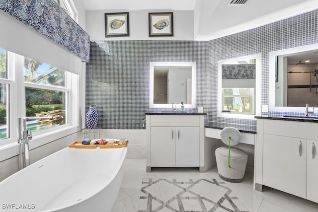 bathroom featuring vanity, tile walls, and shower with separate bathtub