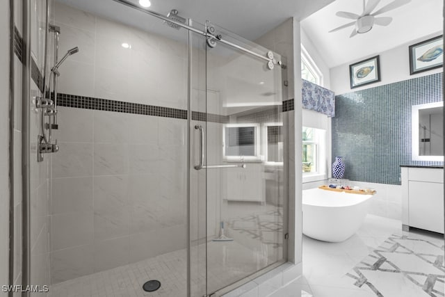 bathroom featuring tile walls, vanity, lofted ceiling, separate shower and tub, and ceiling fan