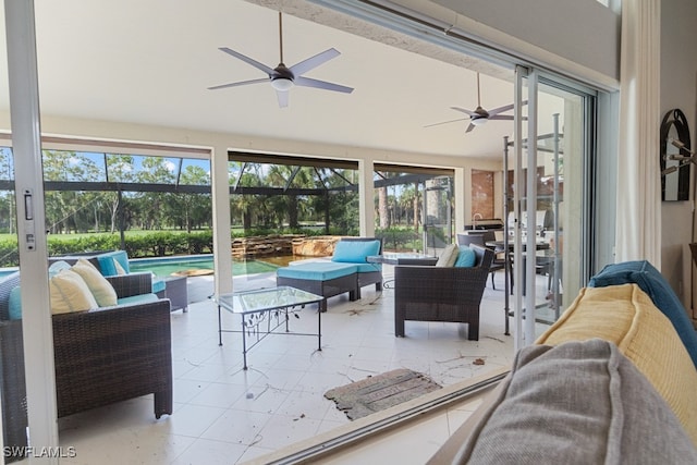 sunroom with a healthy amount of sunlight, ceiling fan, and a swimming pool