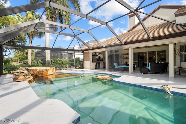 view of swimming pool with a patio, glass enclosure, and a hot tub