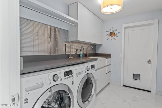 laundry area featuring sink, independent washer and dryer, and cabinets