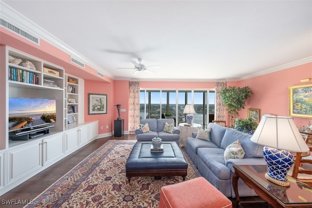 living room with ceiling fan, dark hardwood / wood-style floors, crown molding, and built in shelves