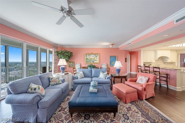 living room with dark hardwood / wood-style floors, ceiling fan, and ornamental molding