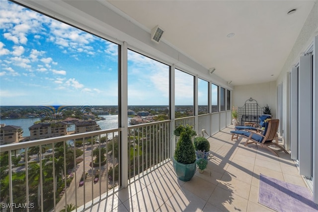 sunroom with a water view and a healthy amount of sunlight