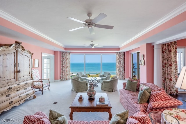 living room featuring light carpet, a water view, ceiling fan, and crown molding