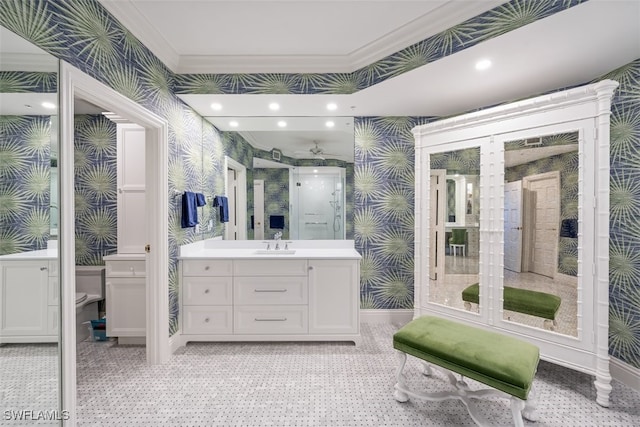 bathroom with vanity, toilet, and ornamental molding