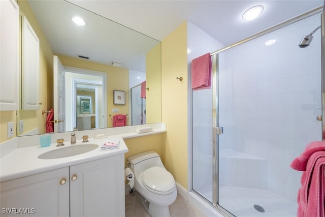 bathroom featuring toilet, an enclosed shower, and vanity