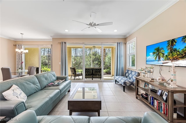 tiled living room with ceiling fan with notable chandelier and ornamental molding