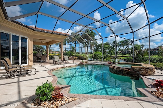 view of swimming pool featuring glass enclosure, a patio area, ceiling fan, and an in ground hot tub