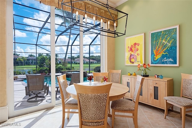 tiled dining room with a wealth of natural light, a water view, and ornamental molding