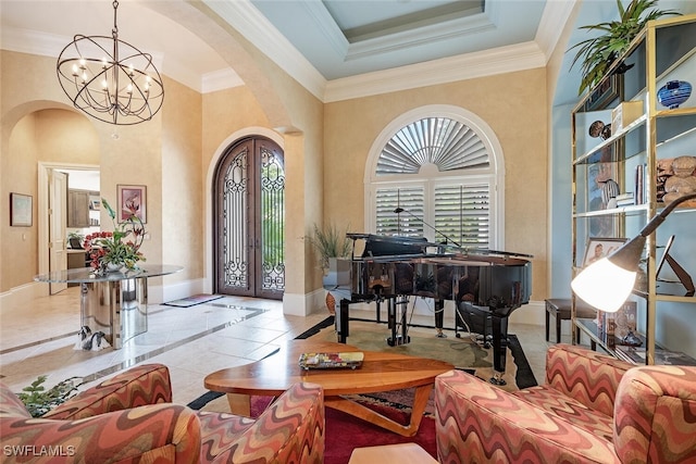 tiled foyer entrance featuring ornamental molding, french doors, and a chandelier