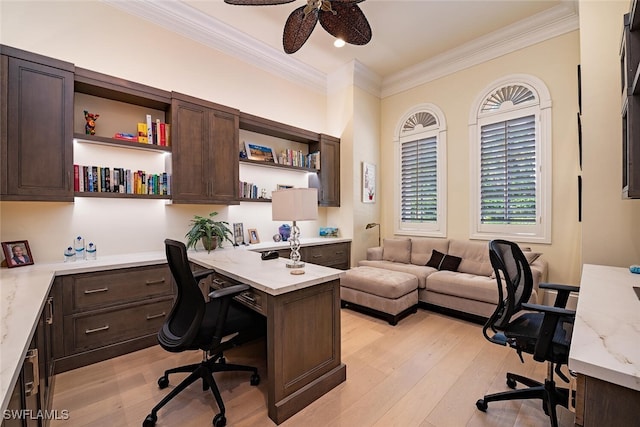 office with light hardwood / wood-style floors, ceiling fan, built in desk, and ornamental molding