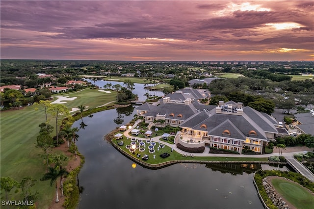 aerial view at dusk featuring a water view