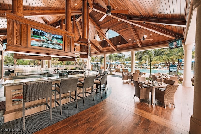 interior space featuring a bar, a gazebo, area for grilling, and ceiling fan