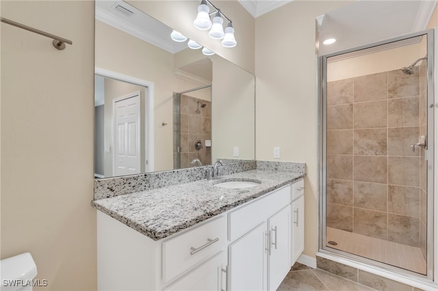 bathroom with vanity, tile patterned flooring, ornamental molding, a shower with shower door, and toilet