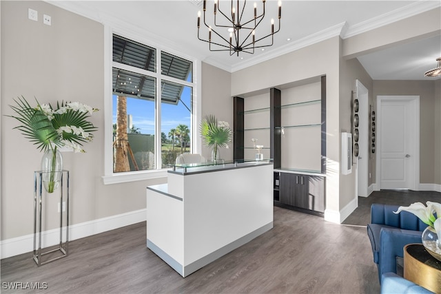 kitchen with ornamental molding, a notable chandelier, hardwood / wood-style flooring, and hanging light fixtures