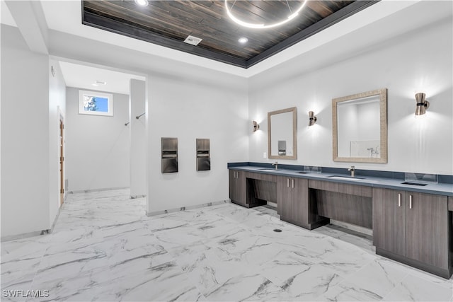 bathroom featuring wood ceiling, vanity, and a tray ceiling