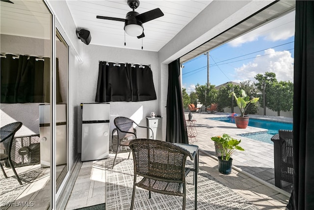 interior space with a swimming pool and ceiling fan