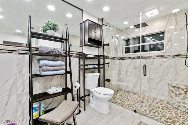 bathroom with toilet, tile walls, and a shower with shower door