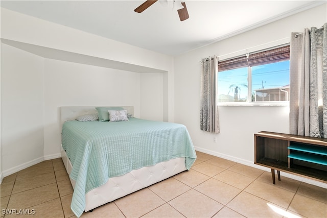 tiled bedroom with ceiling fan