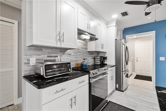 kitchen with dark stone countertops, backsplash, appliances with stainless steel finishes, and white cabinets