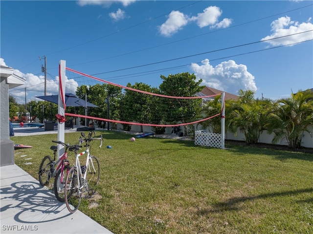 surrounding community with a lawn and volleyball court