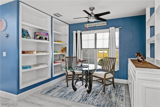 dining area featuring light wood-type flooring and ceiling fan