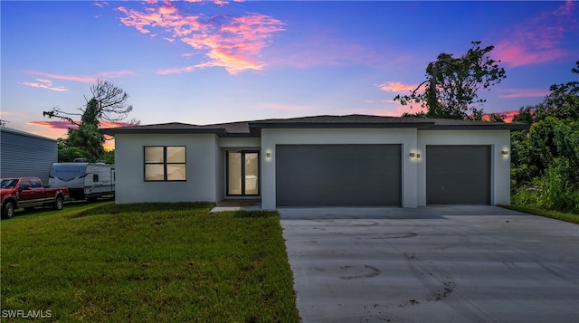 view of front of house with a lawn and a garage