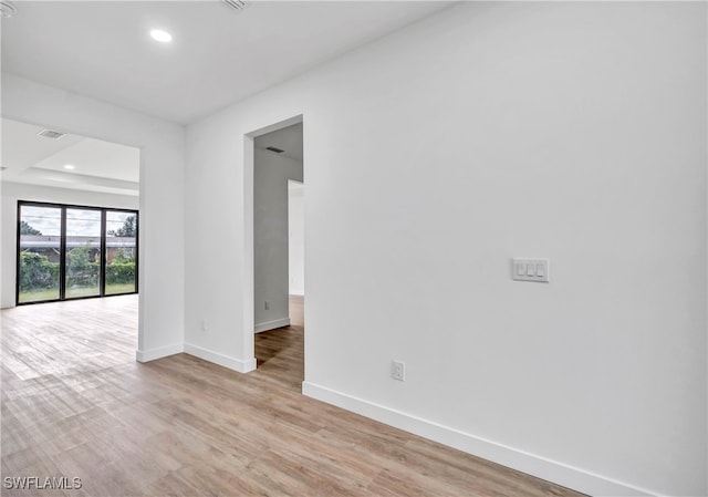 spare room featuring light hardwood / wood-style flooring