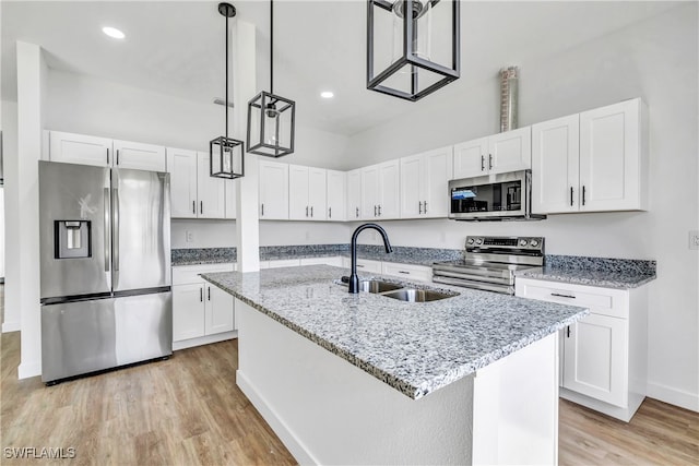 kitchen with a center island with sink, white cabinetry, sink, and appliances with stainless steel finishes