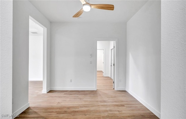 unfurnished room featuring ceiling fan and light wood-type flooring