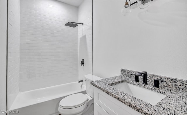 full bathroom featuring tiled shower / bath, vanity, and toilet