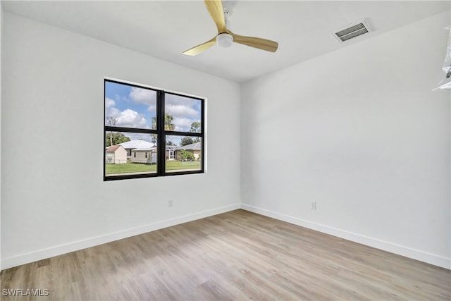 spare room featuring ceiling fan and light hardwood / wood-style floors