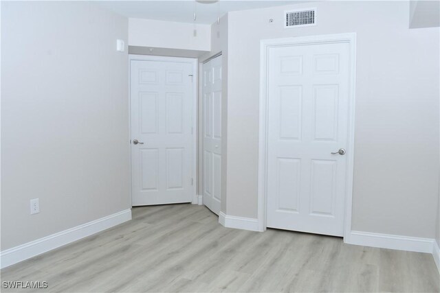 unfurnished bedroom featuring light wood-type flooring