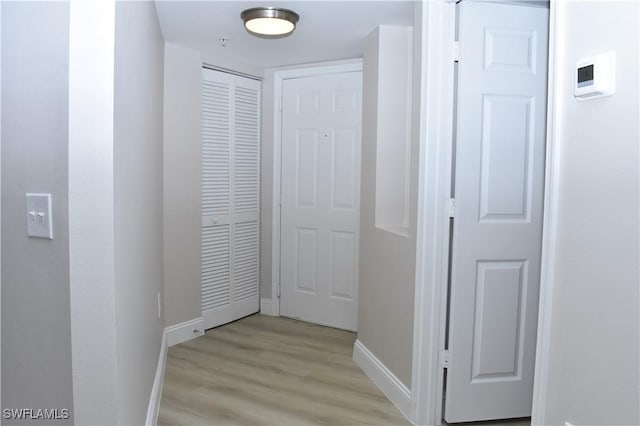 hallway with light hardwood / wood-style flooring